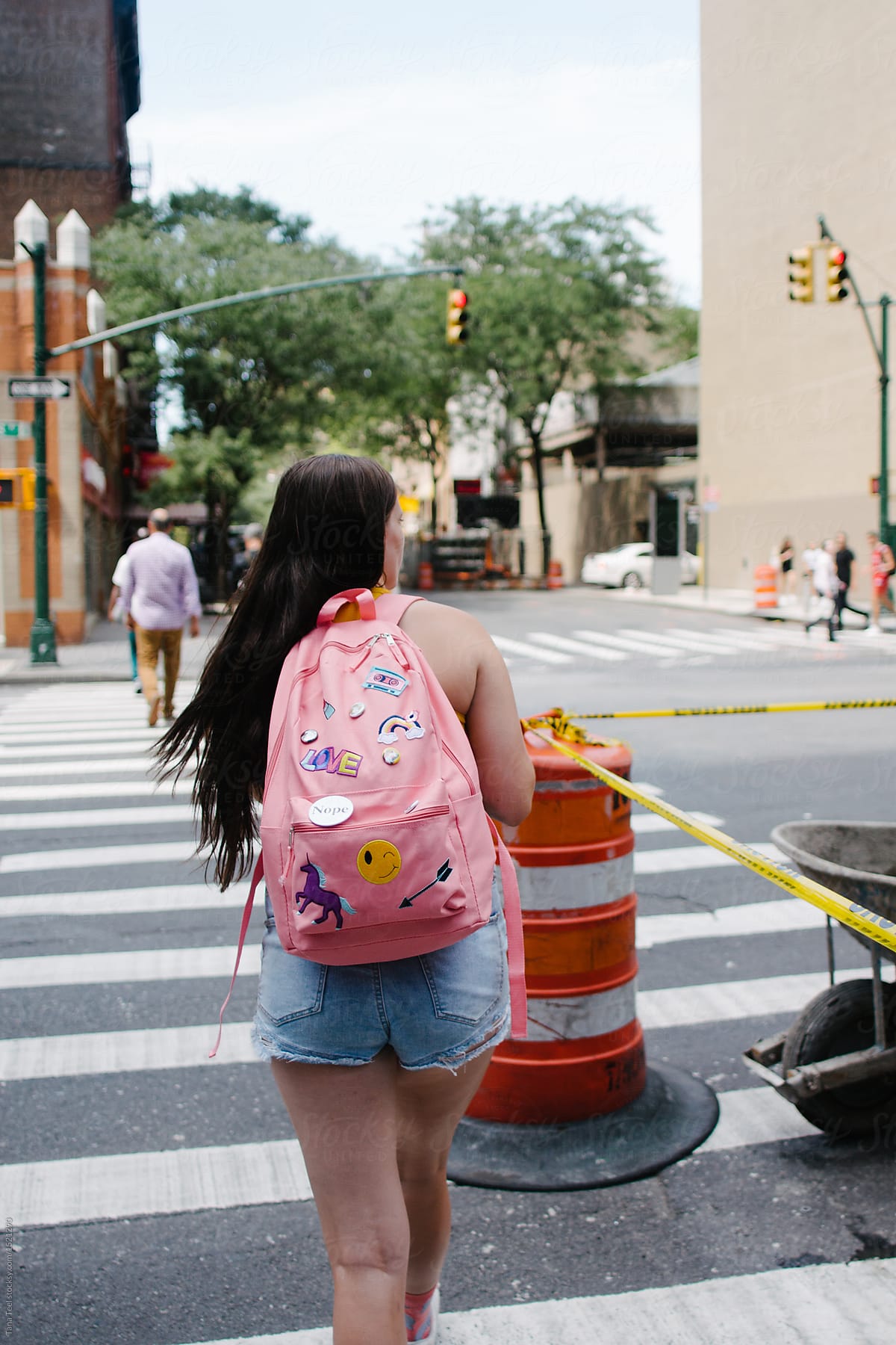 teenager wearing backpack explores NY city