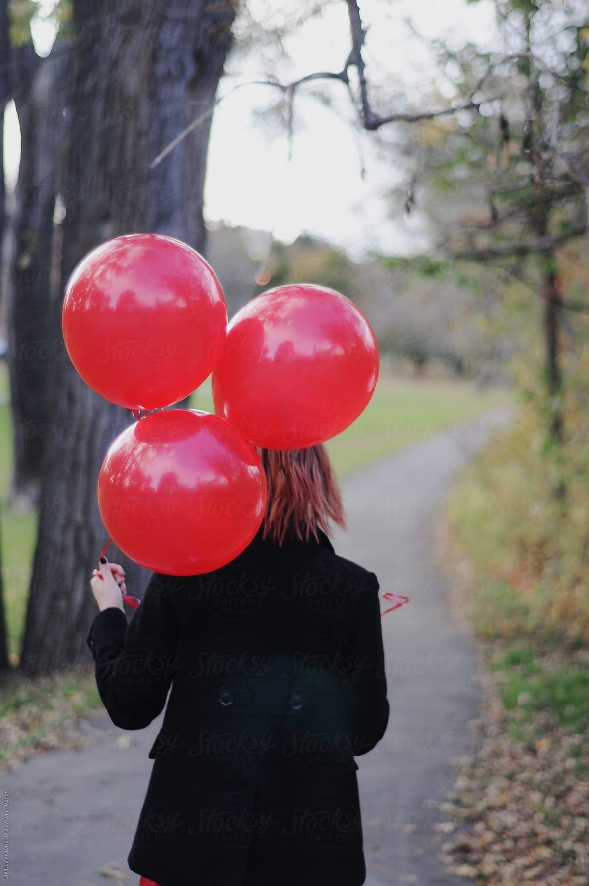 Girl Walking On An Autumn Day With Red Balloons Del Colaborador De Stocksy Chelsea Victoria 