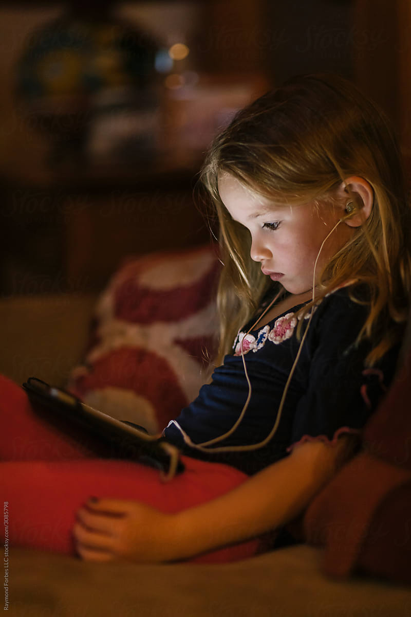 Young Girl on Tablet Computer at Night