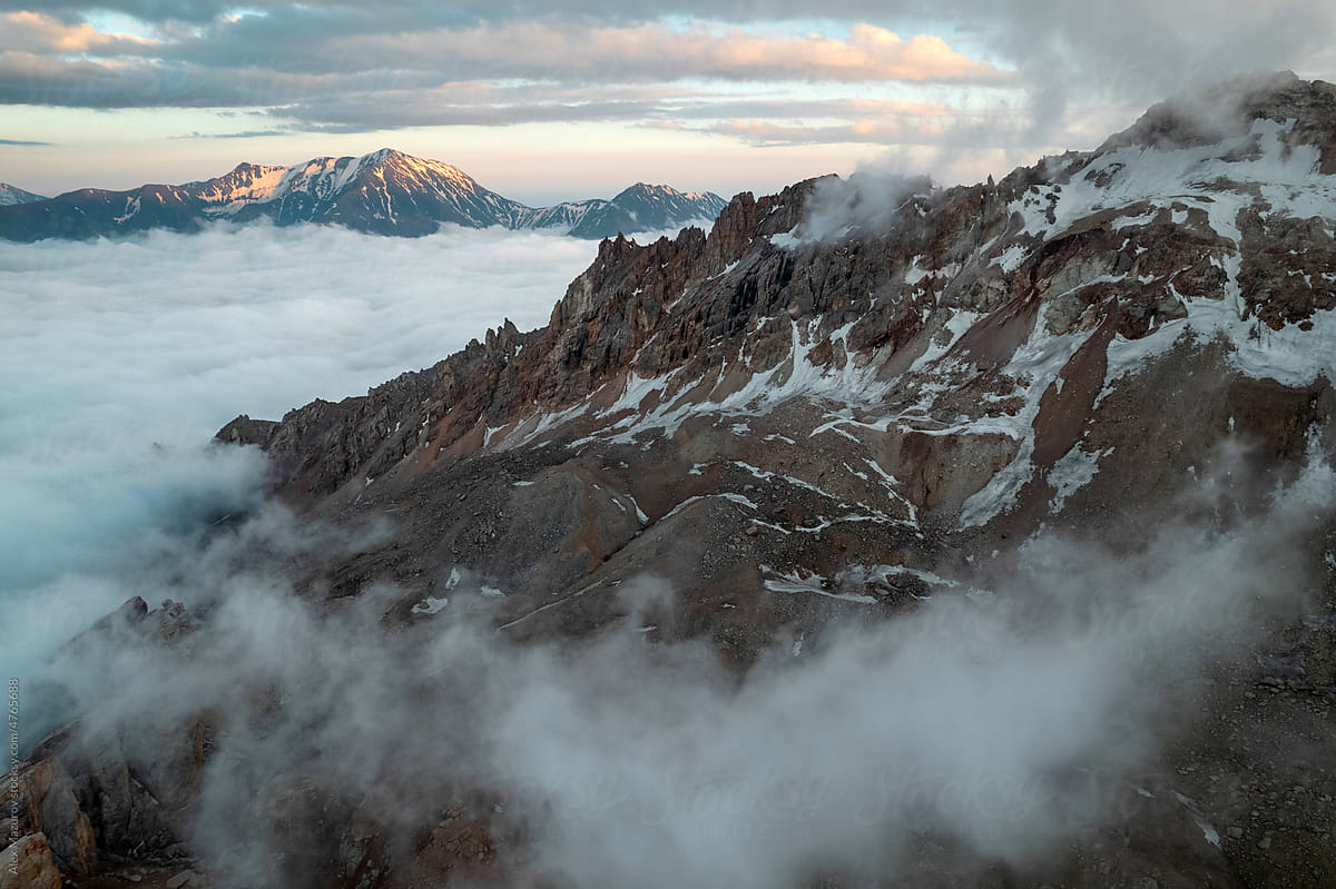 Mountain range with the fog at sunset
