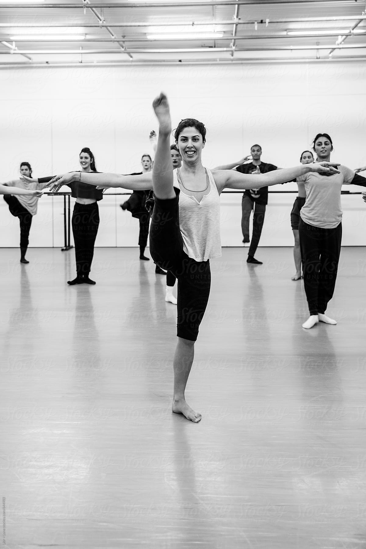 Dancers doing standing splits in dance studio