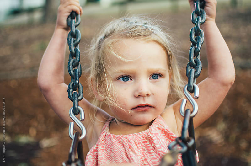 Little girl on a swing set