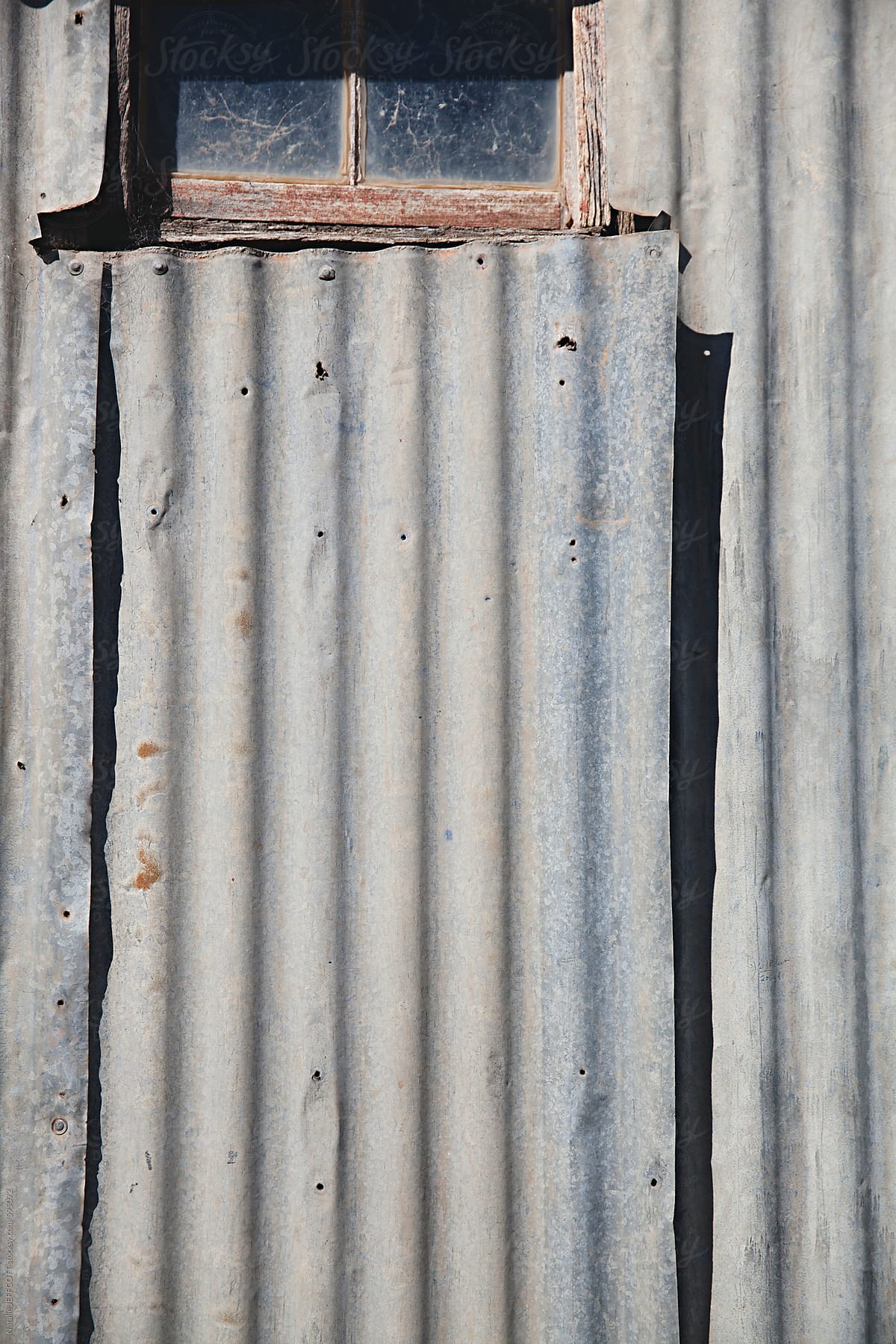 close up of corrugated tin on a shed with harsh shadow