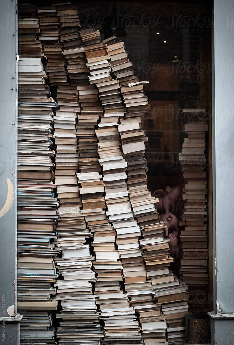 Books stacked up in a window in Paris, France.
