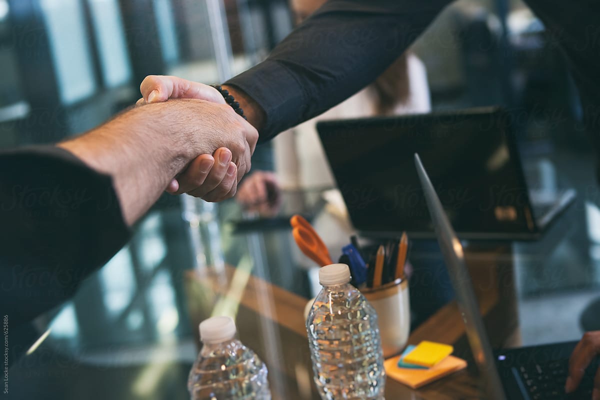 Office: Two Men Shake Hands During Meeting