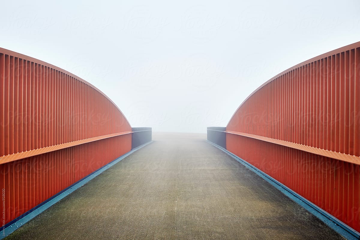 An empty bridge shrouded in fog
