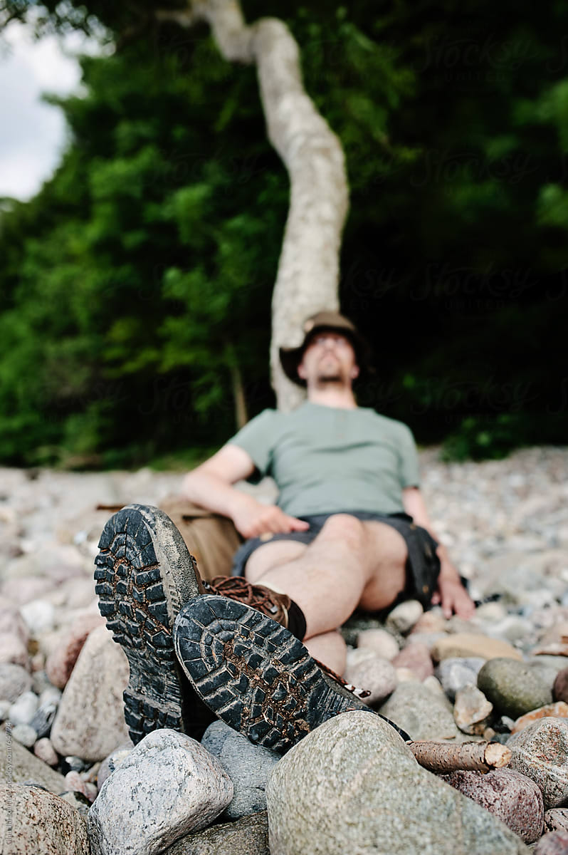 Man Relaxing, Leaning against a Tree Trunk