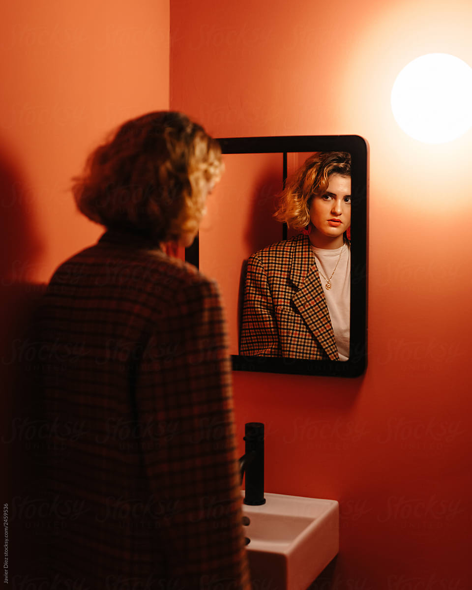Woman standing near mirror