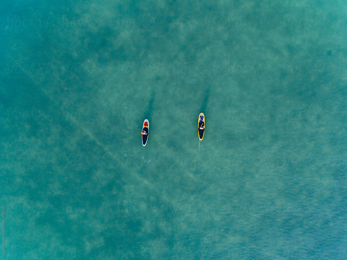 Two women stand up paddleboarding