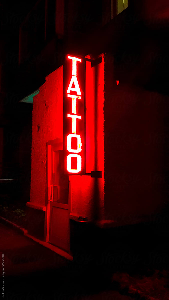 red glowing sign of  tattoo salon
