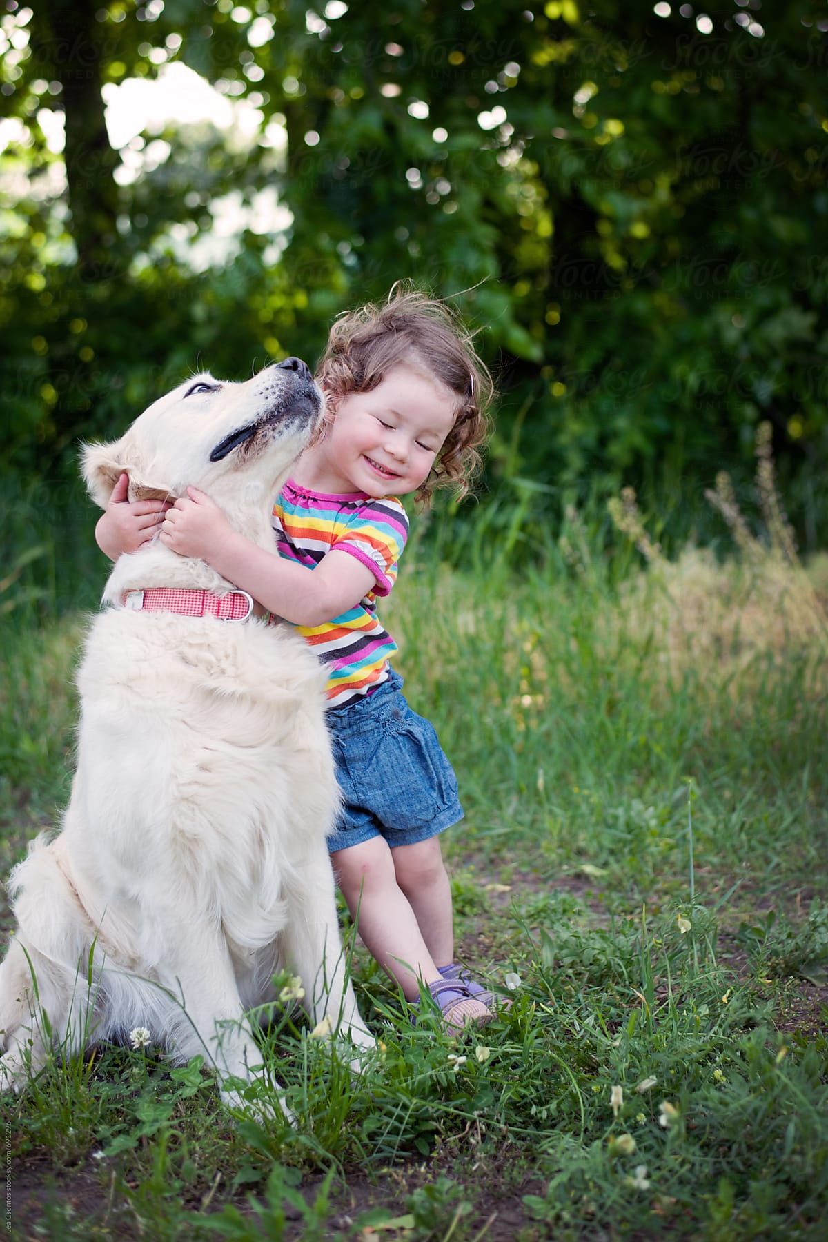 Cute Girl Hugging Her Dog\