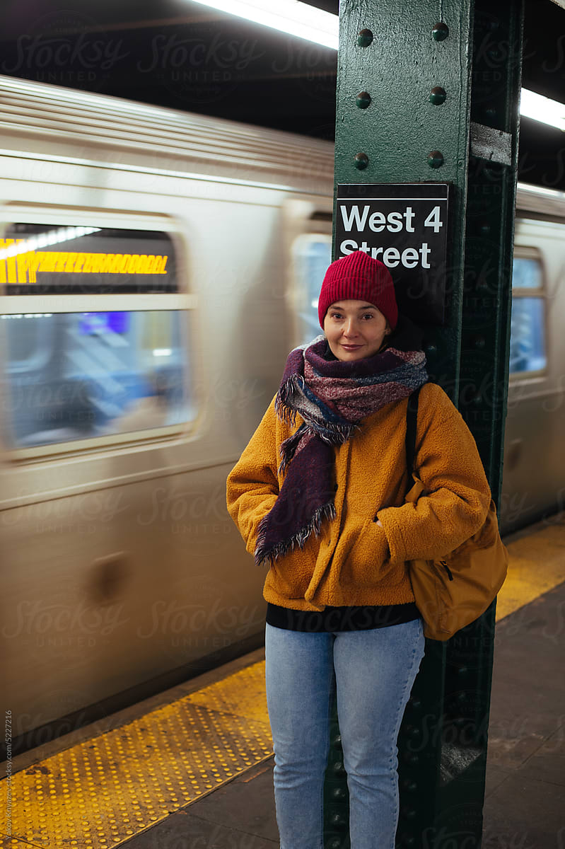 Young female standing on the Subway station