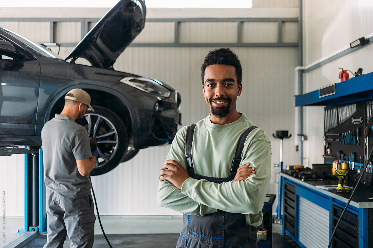 Two Mechanics Repairing Car in Garage