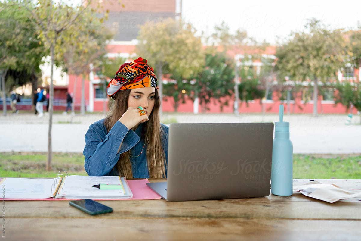 Modern woman using laptop at university campus