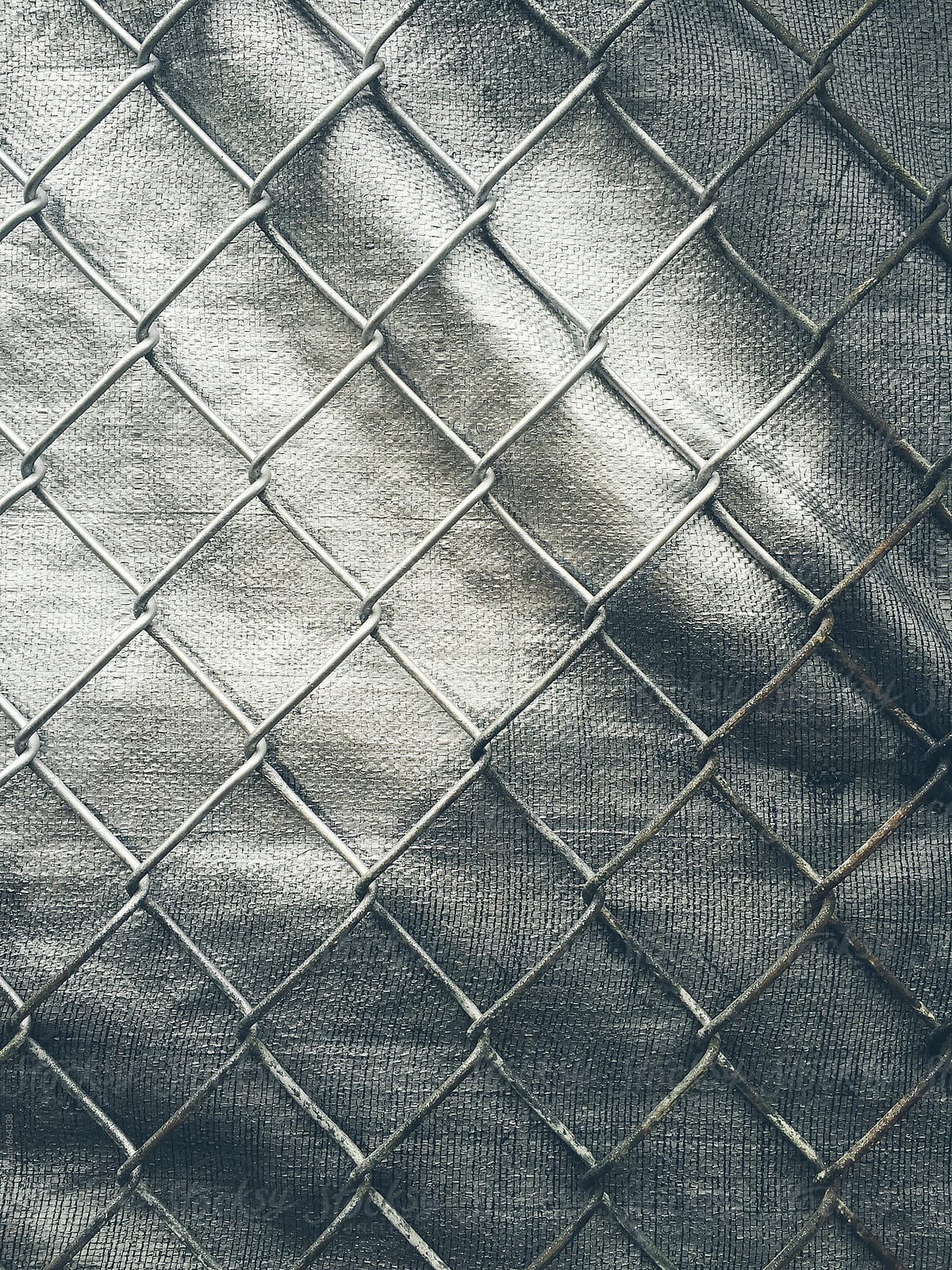 Close up of chain-link fence and silver tarp