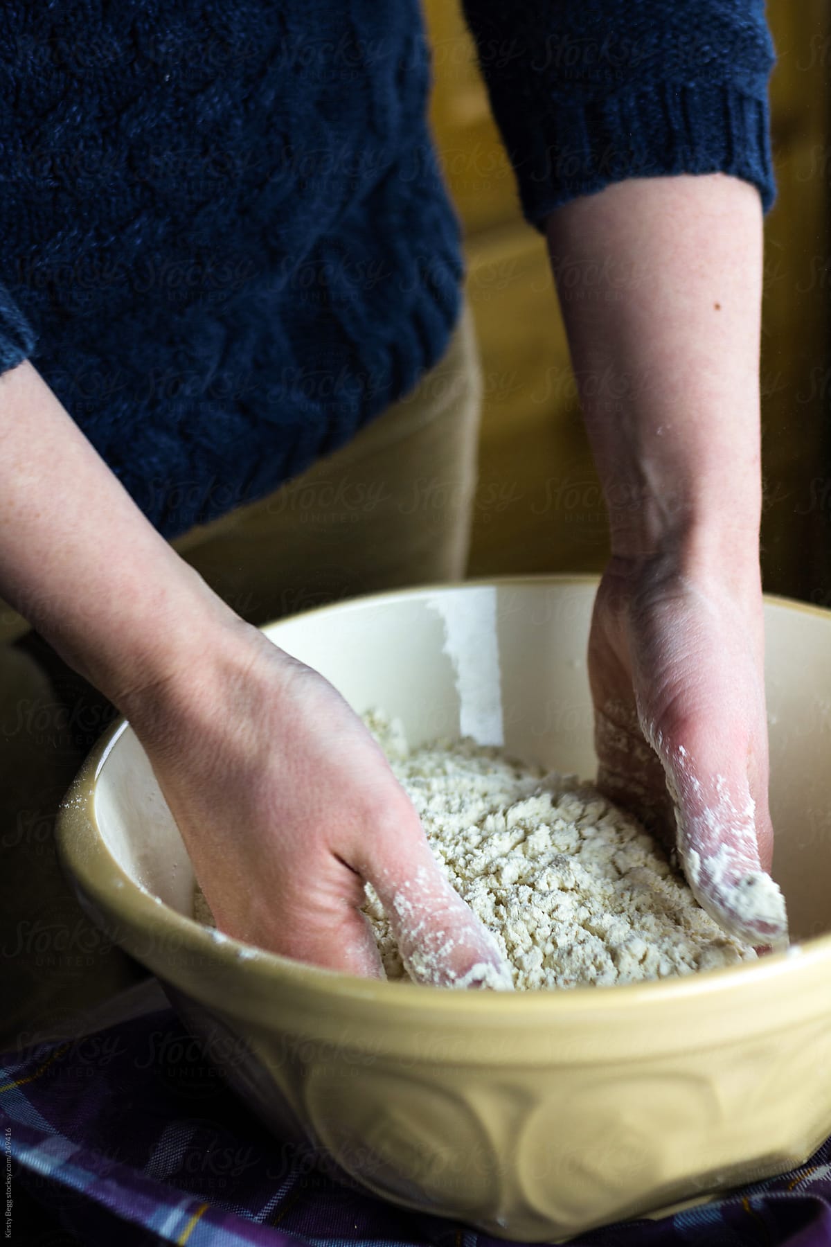 Woman mixing flour to make bread