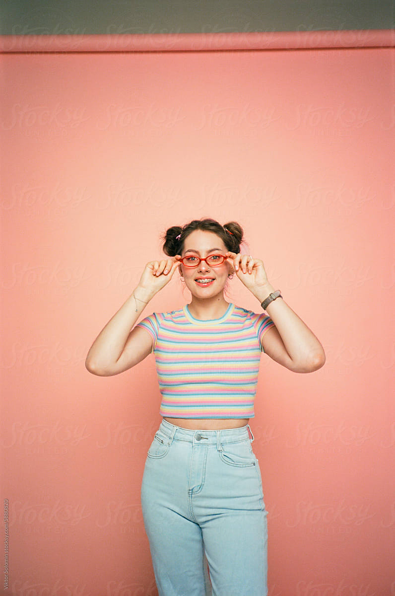 Stylish woman in sunglasses on peachy background