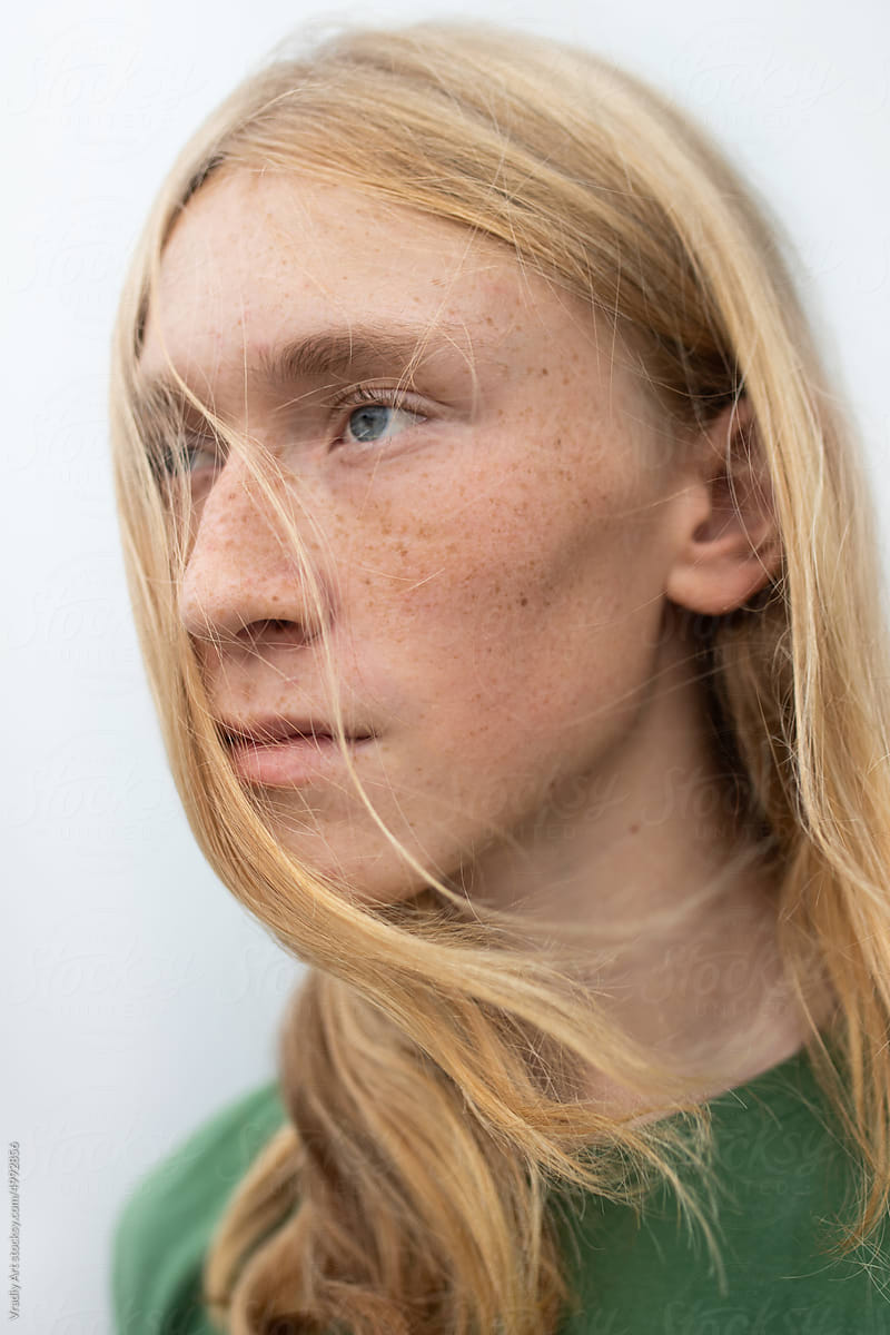 Portrait of young man with blond hair and freckles