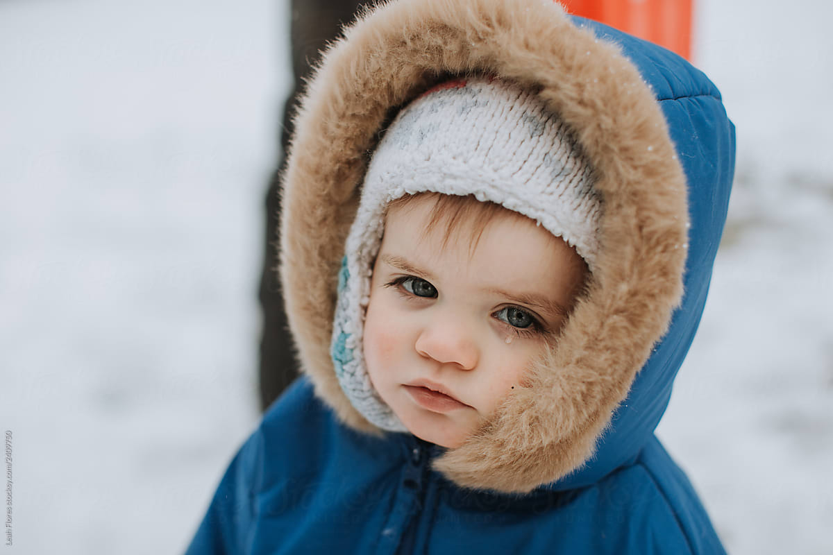 Cute Baby in Snow with Tear on Cheek