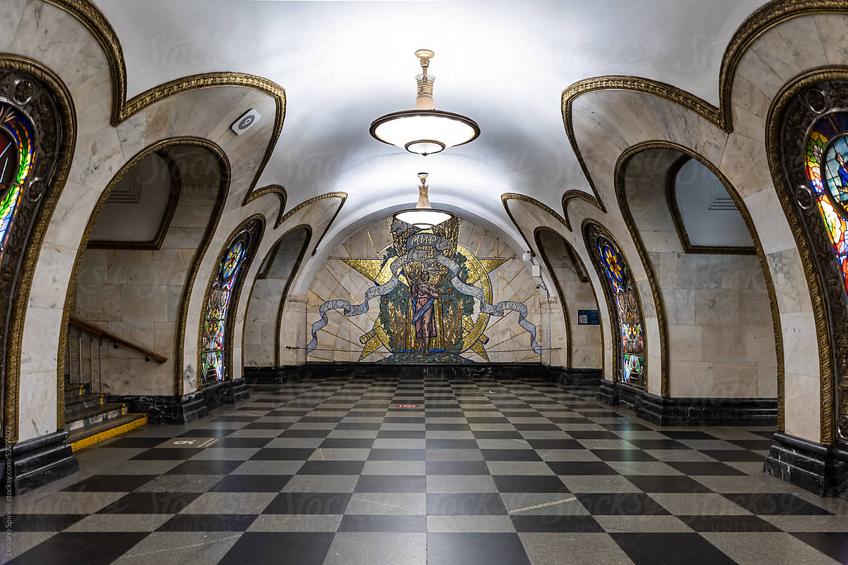 Symmetrical central view of a metro station with golden mosaic