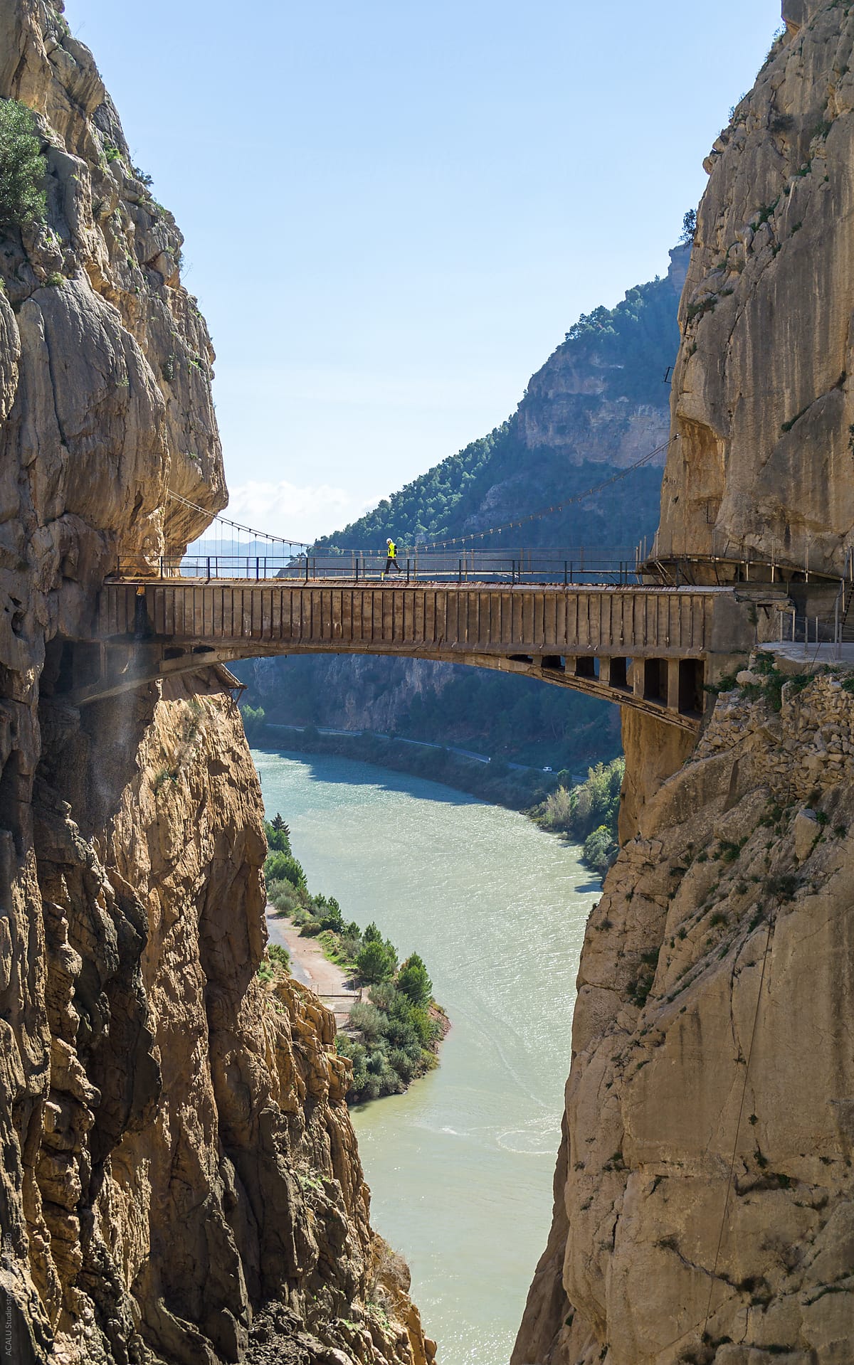 Man walking on the bridge of a canyon in Caminito del Rey