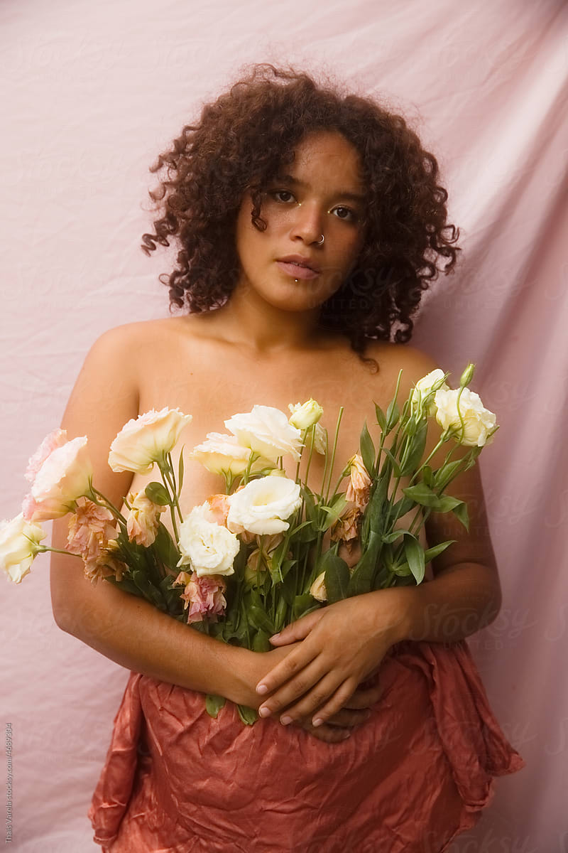 WOMAN HOLDING A BOUQUET OF FLOWERS IN HER HANDS