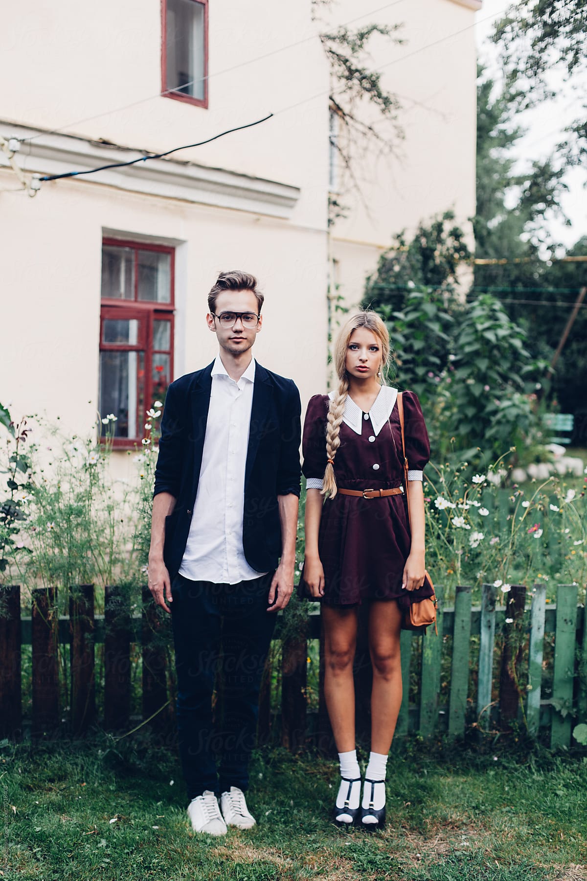 Hipster couple standing straight in the village