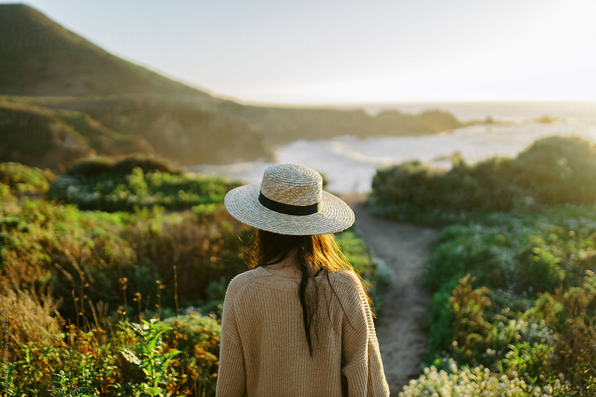 Girl Wearing Hat Walking To The Ocean In Big Sur