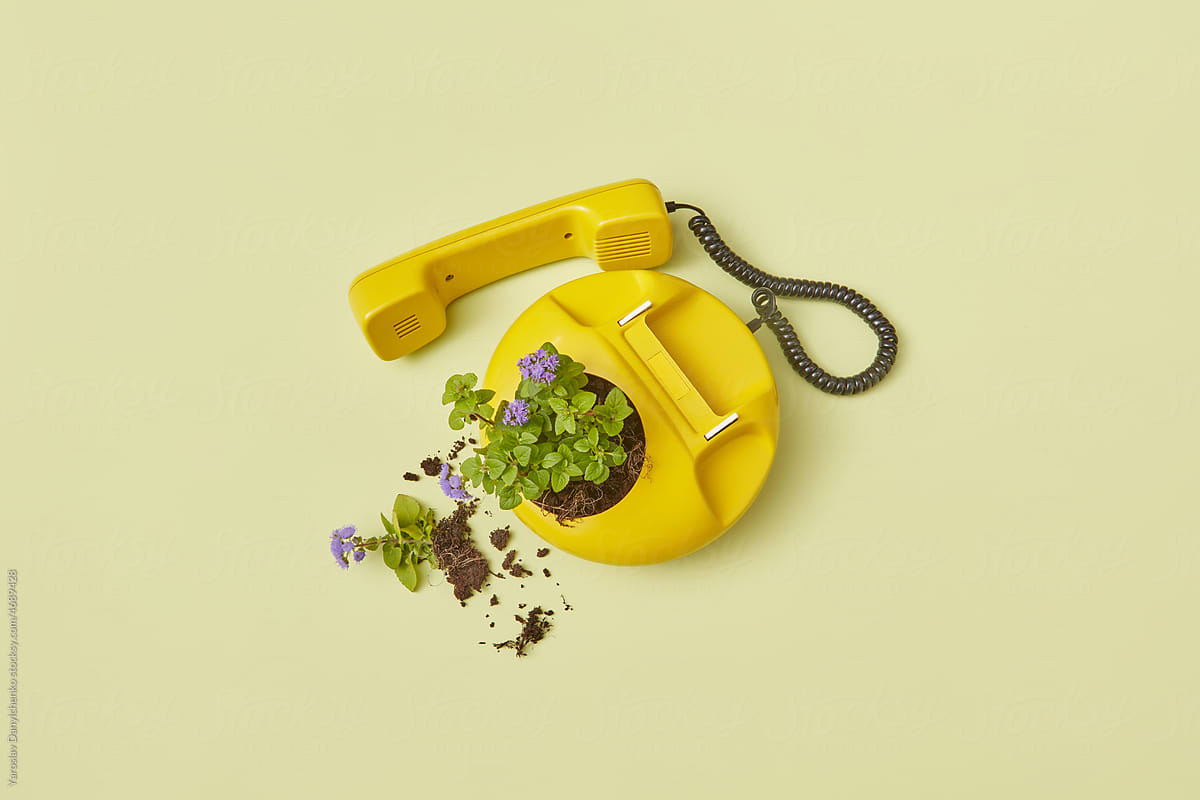 Old-school yellow telephone with flowers