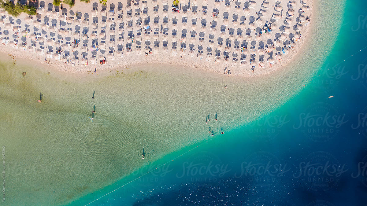 aerial photo of a sandy beach with azure water, paradise resort