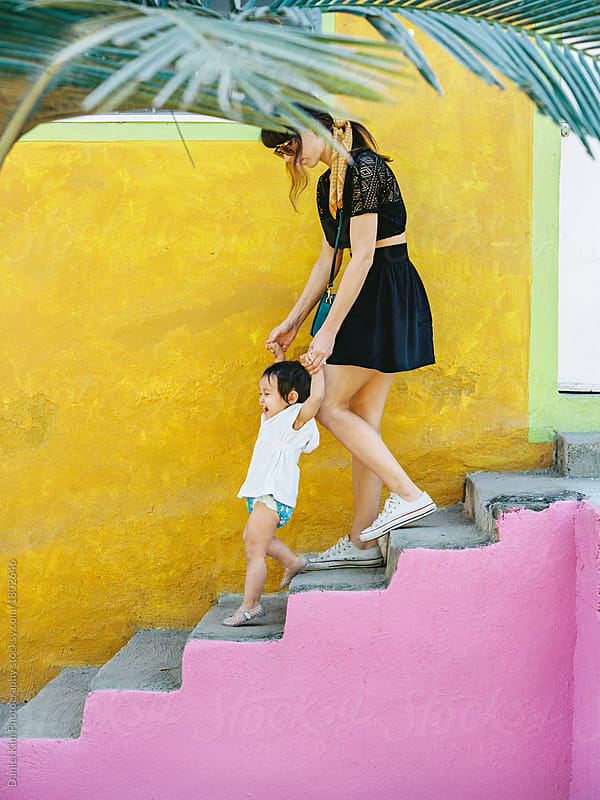 Mom and baby on colorful building steps