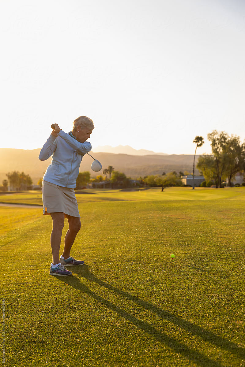 Healthy Senior Citizen Woman Playing Golf from first tee