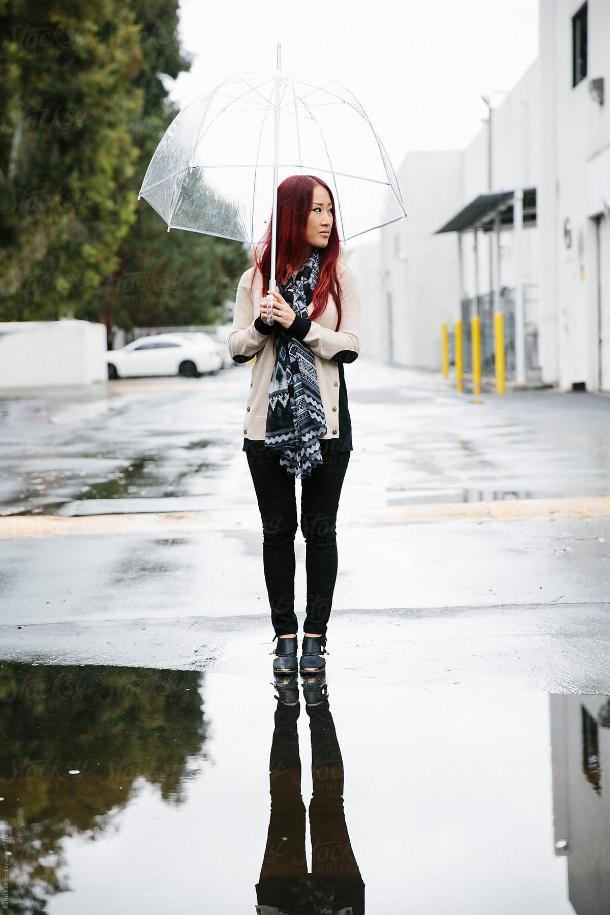 Woman with red hair holding an umbrella