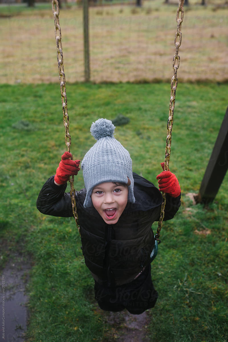 Boy on swing in winter.