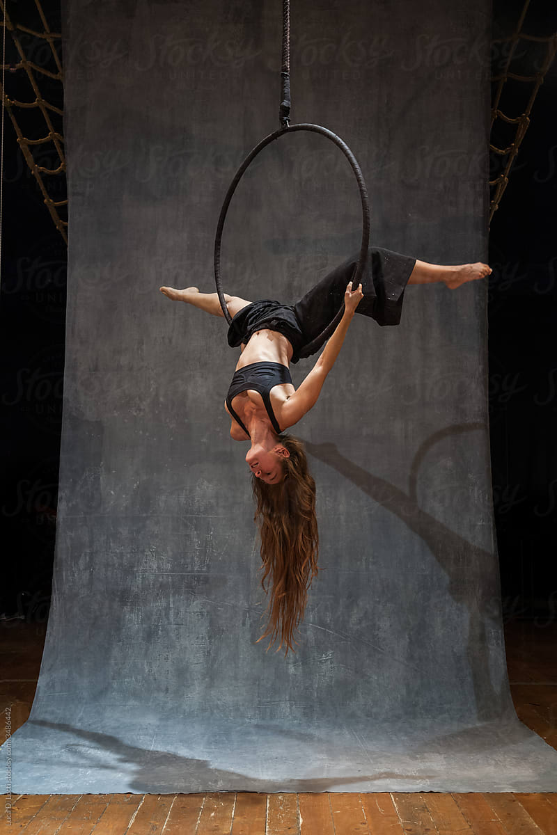Aerial artist suspended to a Lyra or Aerial hoop 11
