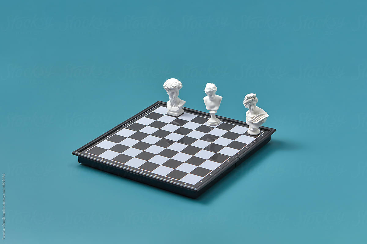Vintage sculptures on one side of chessboard.
