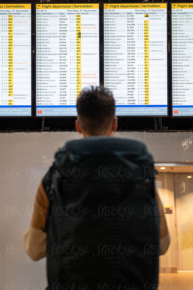 Lone traveller checking flight schedule.