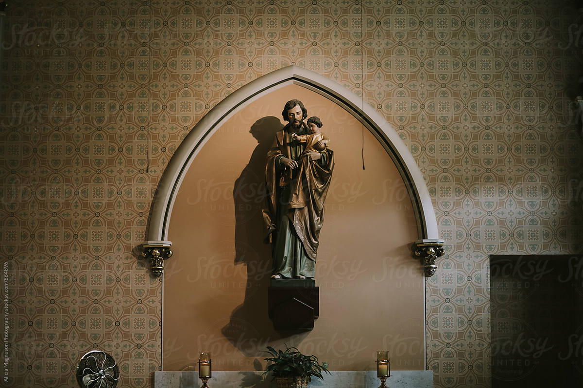 Interior wall of Ornate Catholic Church Sanctuary with Statue