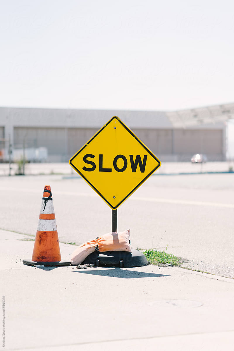 Slow sign and orange traffic cone