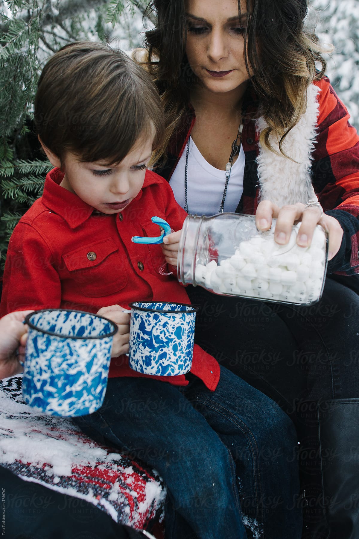 mother and son enjoying marshmallows and cocoa