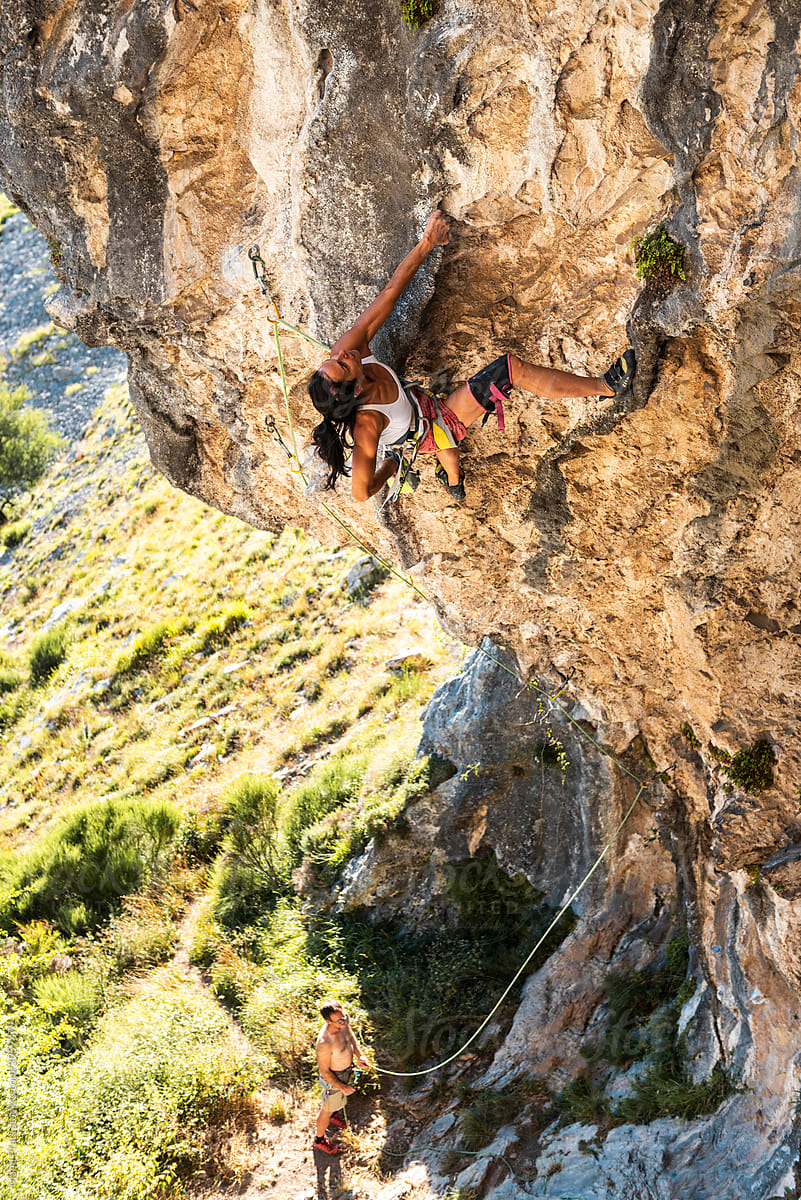 Mature sportswoman rock climbing