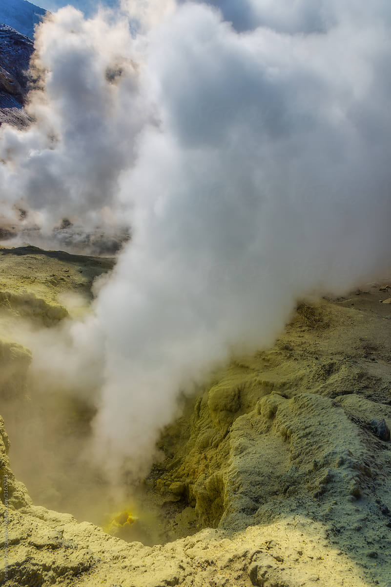 Smoking fumaroles with emitting volcanic vapor.