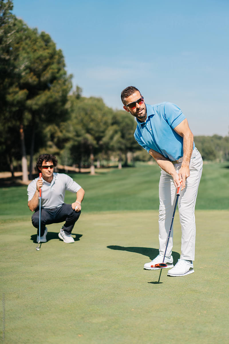 Adult men playing golf together
