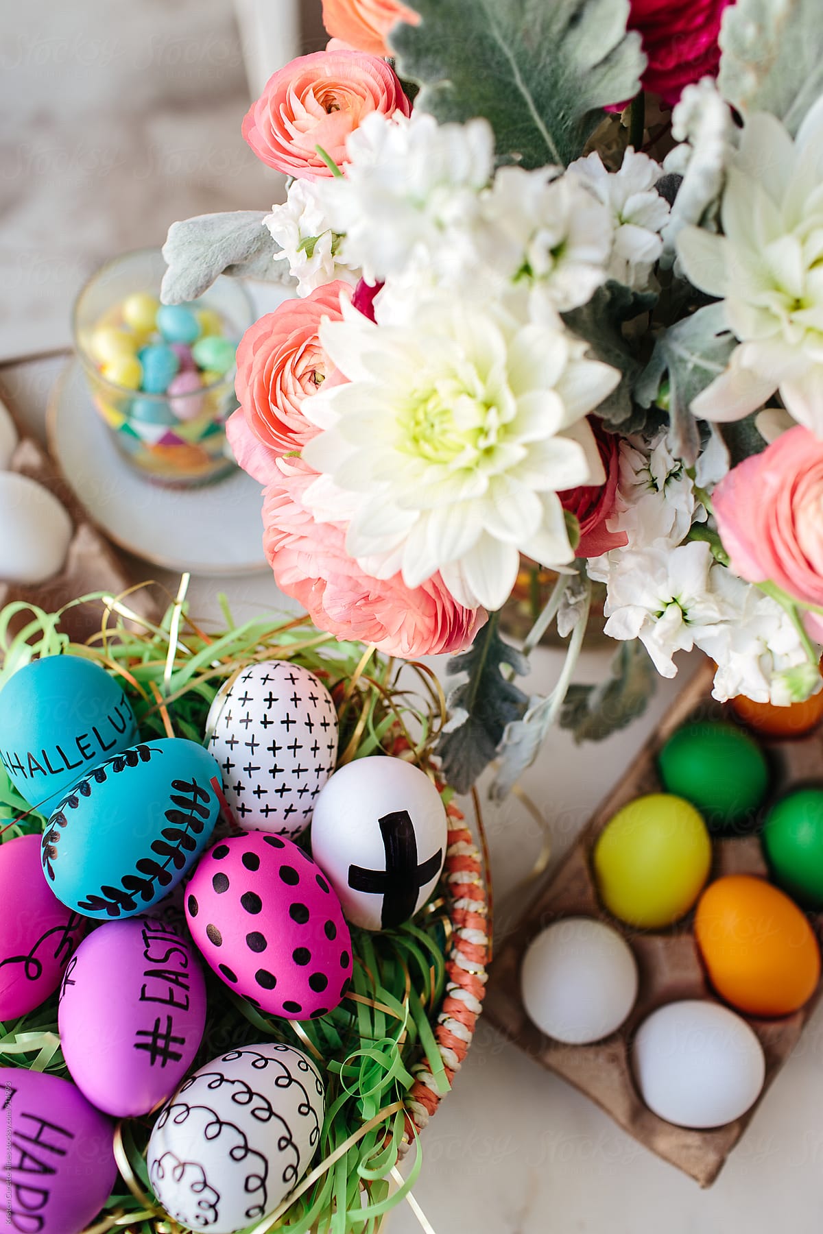Hand drawn & colored easter eggs next to fresh cut flowers