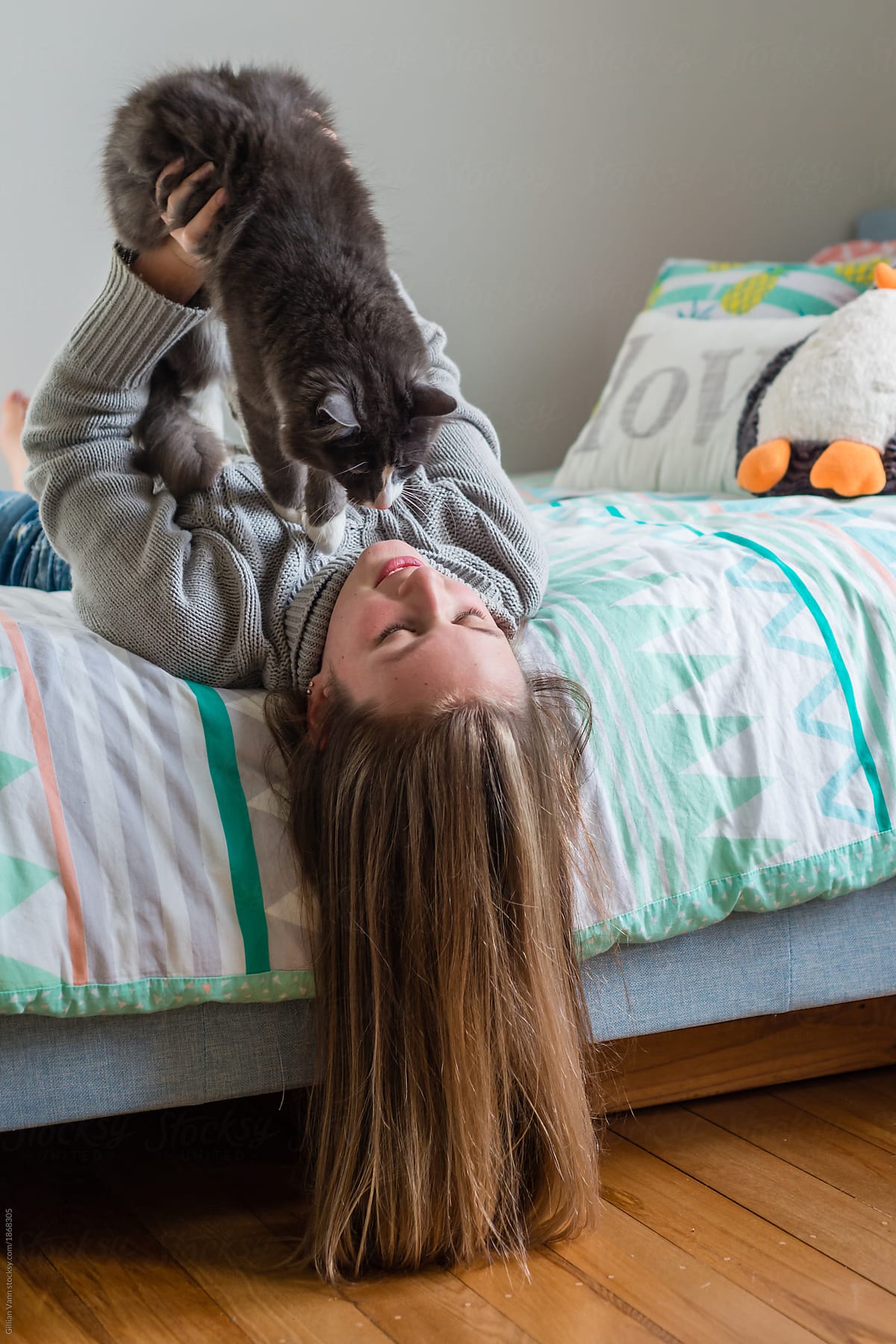 teen girl in bedroom with her cat,