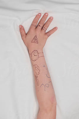 Boy's Hand With Pen Tattoos Close Up