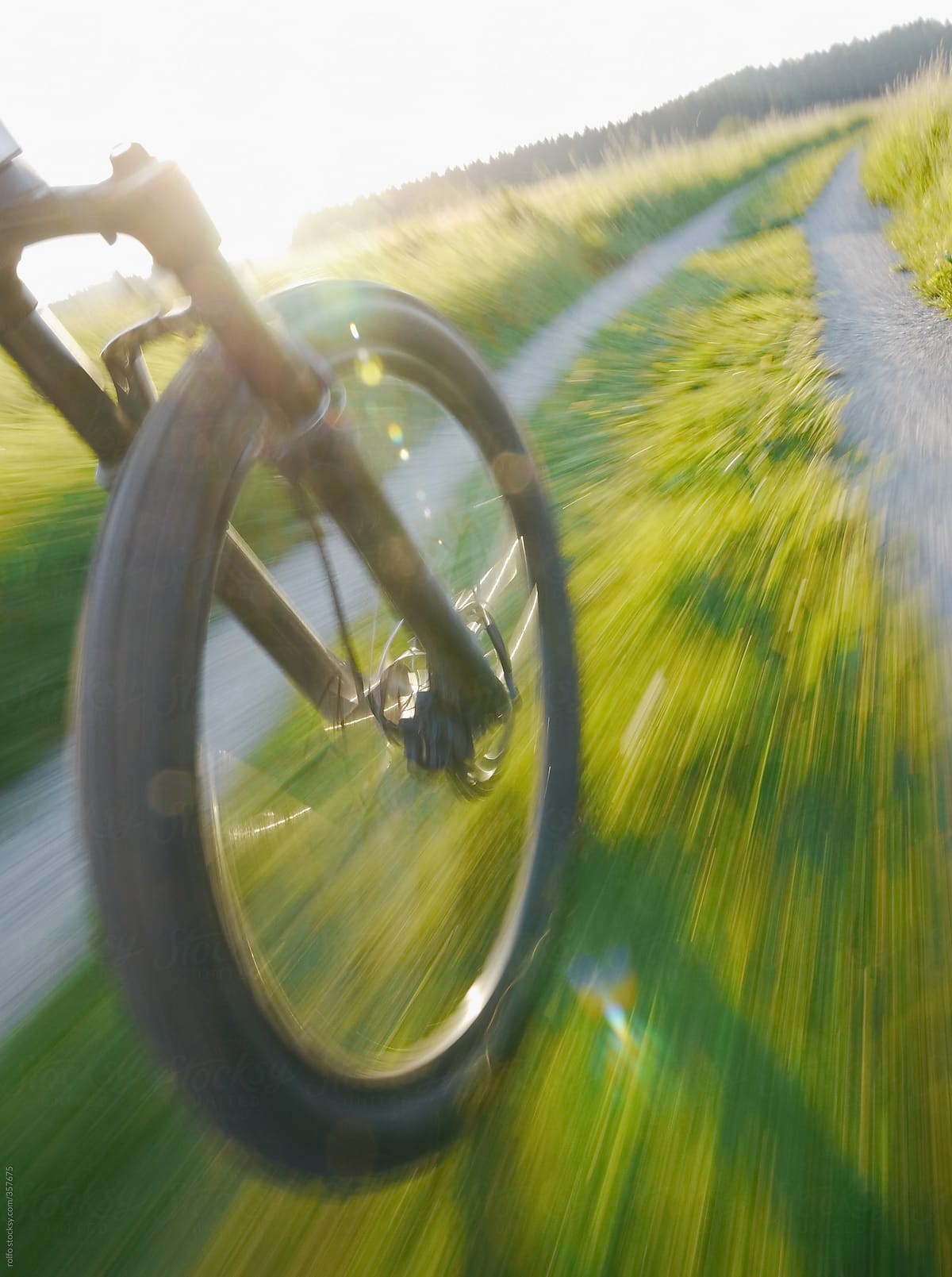 bike wheel motion blurred along a path