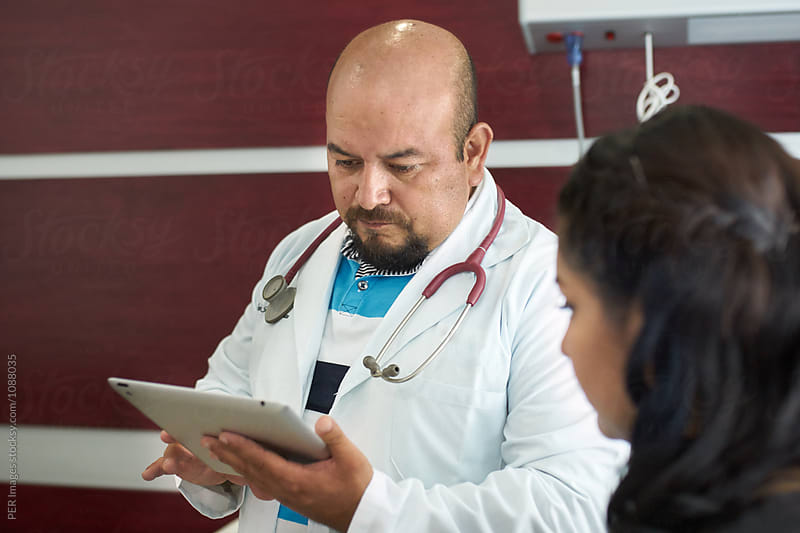Doctor reading patient's file with a tablet