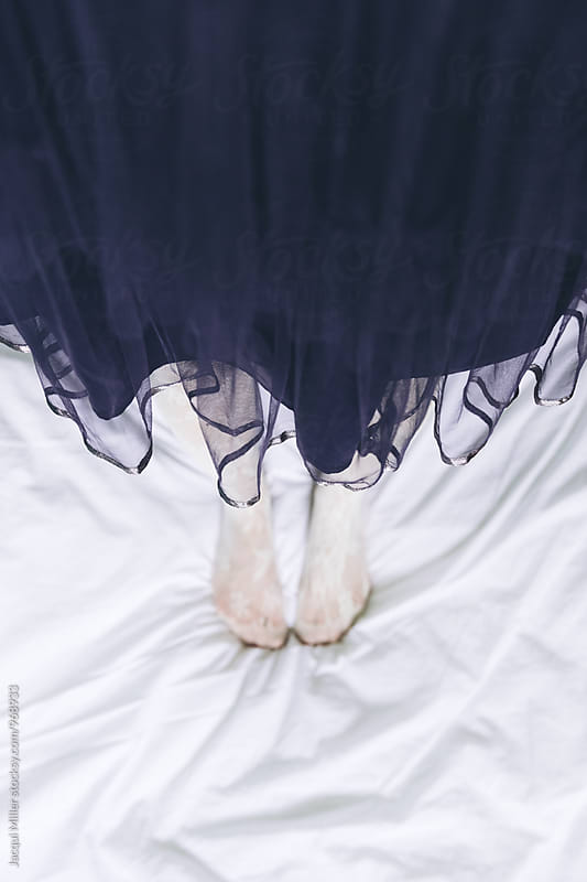 Looking down on feet of woman wearing tulle skirt