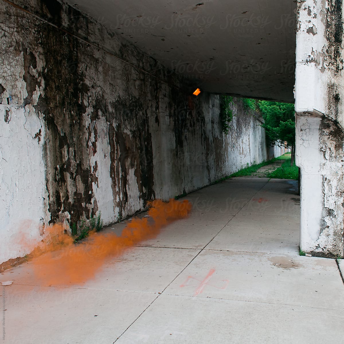 orange smoke under an overpass